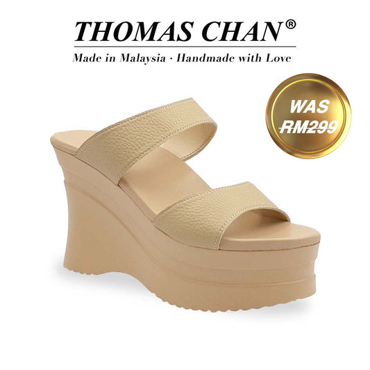 Diagonal view of Thomas Chan's Minimalist Slip-on Heels in light mustard cream with a 4-inch platform wedge sole, featuring two wide textured lychee-finish straps and a cushioned footbed for added comfort. "THOMAS CHAN®" brand displayed with "Made in Malaysia · Handmade with Love" below. Gold and white banner highlights special offer: "Was RM299"