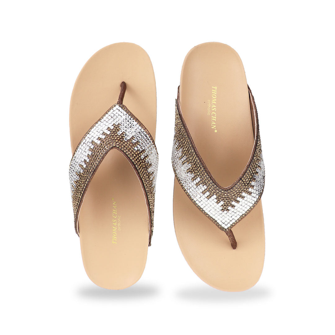 Studio shot of bronze suede rhinestone flip-flops showing the full front design with sparkling rhinestone straps and smooth cushioned sole.