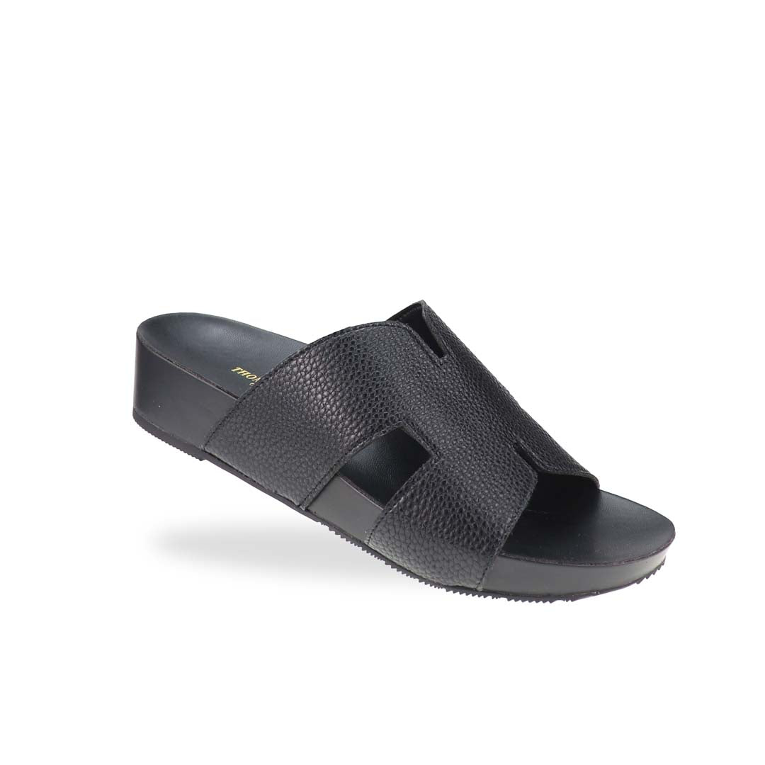 A stylish angle of the H-Strap Pebble Lychee Flatform Sandals in black, highlighting the textured material and smooth, cushioned footbed for all-day comfort.