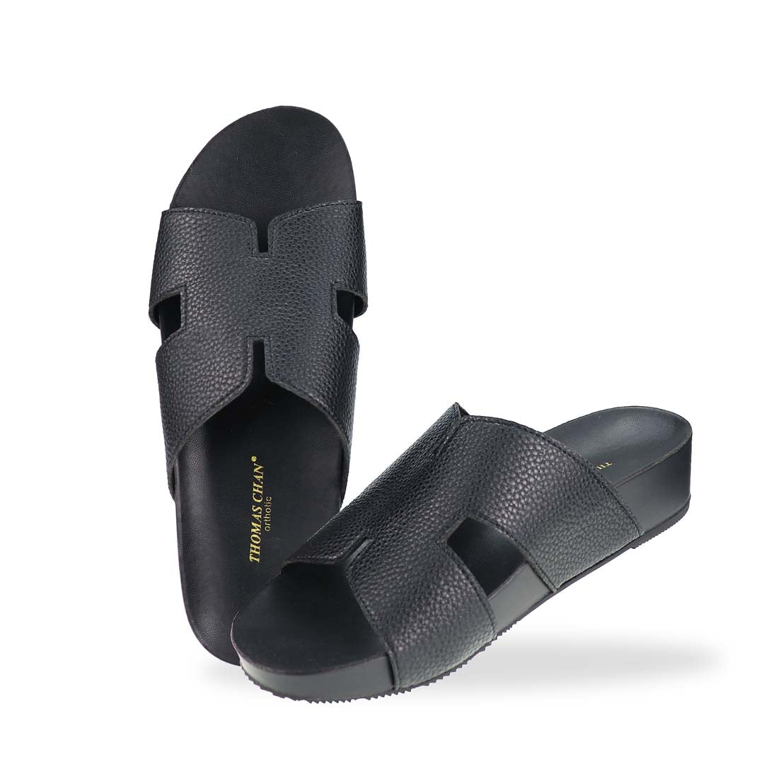 A complete top-down look at the H-Strap Pebble Lychee Flatform Sandals in black, emphasizing the minimalist design and wide-fit coverage