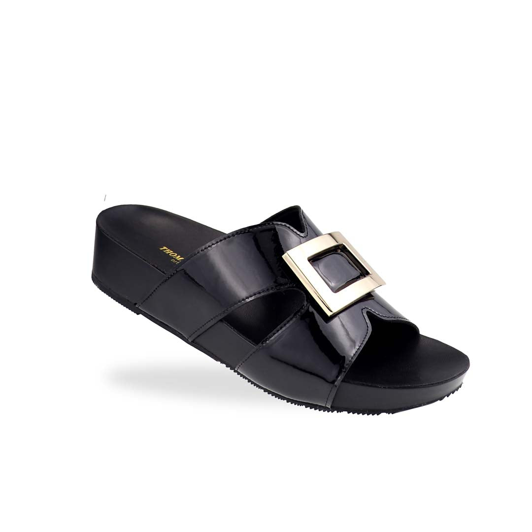 Thomas Chan LiteStep flatform sandals in black patent leather with square gold buckle, displayed diagonally on white studio background.