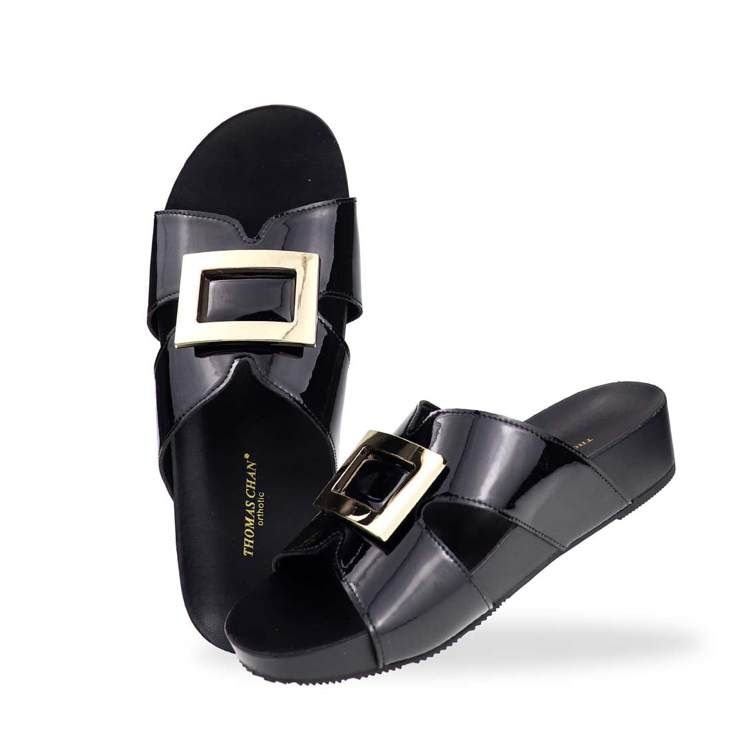 Full view of Thomas Chan LiteStep flatform sandals in black patent leather with square gold buckle, on white studio background.