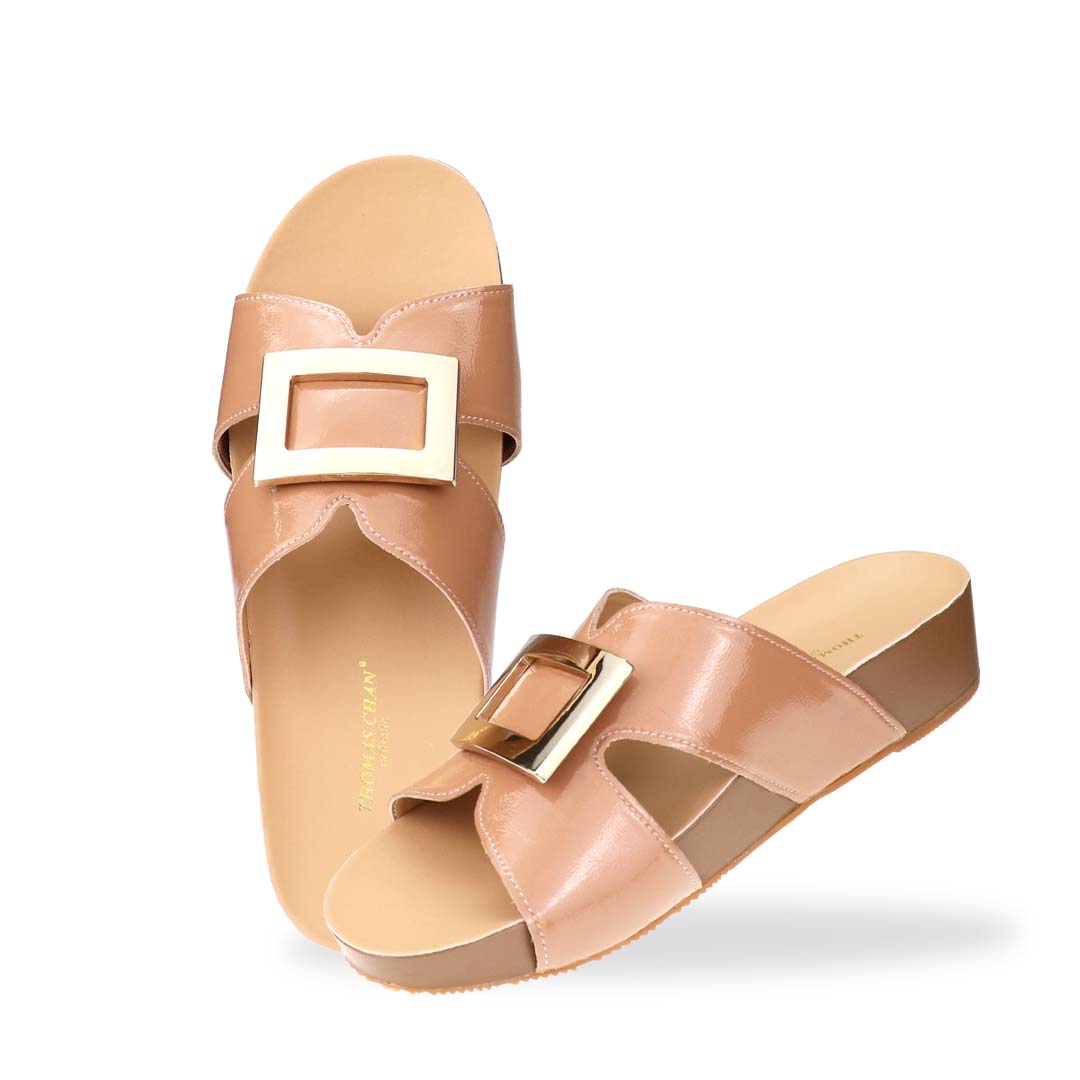 Full view of Thomas Chan LiteStep flatform sandals in nude patent leather with square gold buckle, on white studio background.