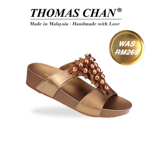 Diagonal view of Thomas Chan Petal Pearl Flatform Sandals in bronze—highlighting pearl-petal embellishments and gentle height from LiteStep sole. The "THOMAS CHAN®" brand is displayed with "Made in Malaysia · Handmade with Love" below. A gold and white banner highlights a special offer: "Was RM269."