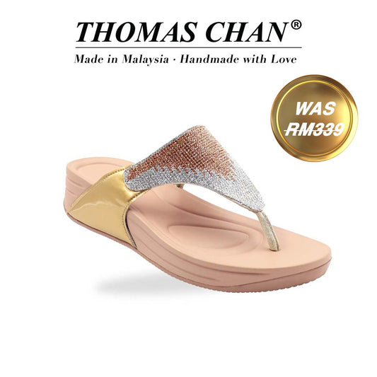 A close-up diagonal shot of the Diamond Embellished Flip-Flop Sandals from the Bounce Care Series, placed on a clean studio background. The shimmering crystal-embellished straps catch the light, while the cushioned flatform sole is visible from the side, highlighting its gentle elevation and soft rubber texture. The 'THOMAS CHAN®' brand logo is clearly visible, with the inscription 'Made in Malaysia · Handmade with Love' underneath. A gold and white banner showcases the special offer: 'Was RM339.'