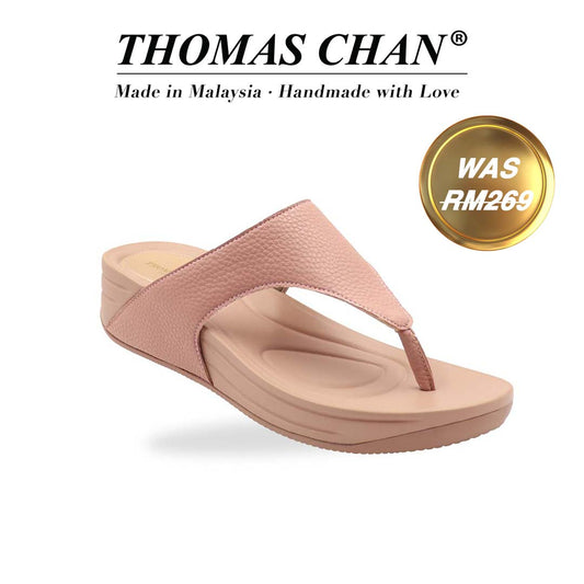 Thomas Chan’s pastel-tone pink flip-flop sandals shot at a diagonal angle in a studio setting, showcasing the pebbled lychee texture and contoured Bounce Care footbed. The 'THOMAS CHAN®' brand logo is clearly visible, with the inscription 'Made in Malaysia · Handmade with Love' underneath. A gold and white banner showcases the special offer: 'Was RM269.'