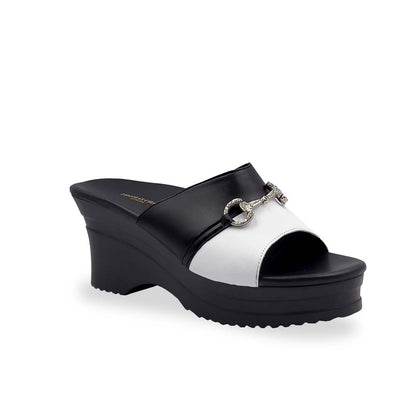 Diagonal view of Thomas Chan Two-Tone Horsebit Buckle Wedge Heels  from Cushioned Heel Series, featuring a black and white upper with a silver horsebit buckle accent, set on a beige cushioned platform sole. 