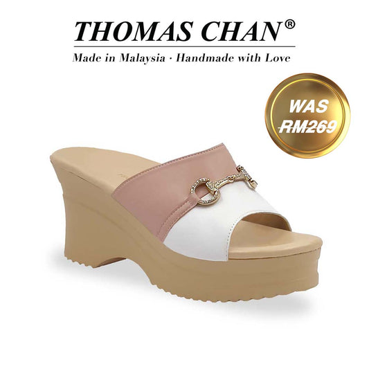 Diagonal view of Thomas Chan Two-Tone Horsebit Buckle Wedge Heels  from Cushioned Heel Series, featuring a blush pink and white upper with a gold horsebit buckle accent, set on a beige cushioned platform sole. "THOMAS CHAN®" brand displayed with "Made in Malaysia · Handmade with Love" below. Gold and white banner highlights special offer: "WAS 269."