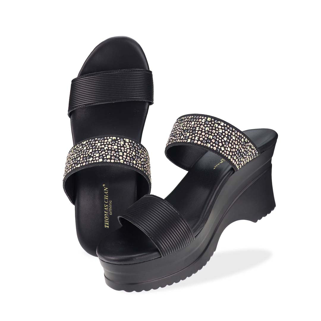 Full view of Thomas Chan's Strappy Rhinestone Cushioned Heels in black: With a built-in cushioned footbed and a chic two-strap design, these heels offer a sleek front stripe complemented by a dazzling rhinestone strap at the back.