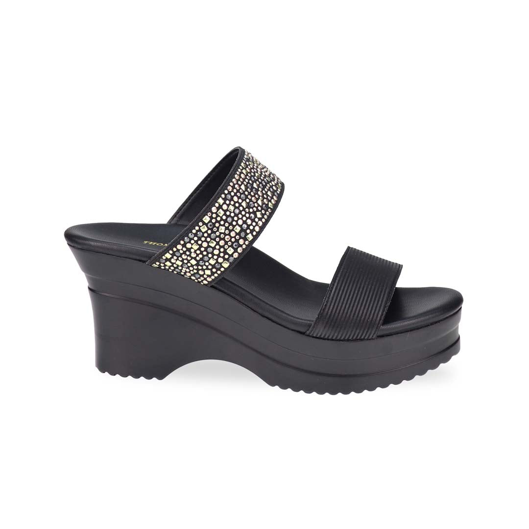 Side view of Thomas Chan's Strappy Rhinestone Cushioned Heels in black: With a built-in cushioned footbed and a chic two-strap design, these heels offer a sleek front stripe complemented by a dazzling rhinestone strap at the back.