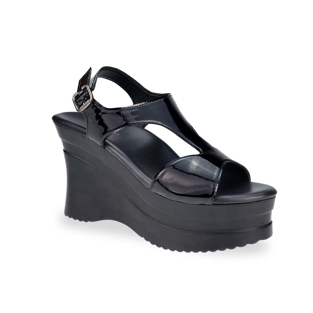 A dynamic diagonal shot highlighting the structured silhouette, 4-inch heel, and elegant shine of the patent leather.