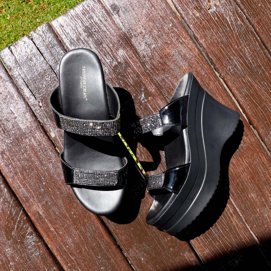The Multi-Row Diamond Heels displayed on a rustic wooden floor in a pavilion setting, illuminated by natural sunlight, creating a warm and elegant ambiance.