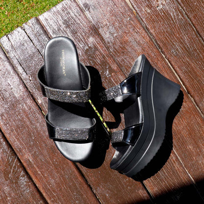 The Multi-Row Diamond Heels displayed on a rustic wooden floor in a pavilion setting, illuminated by natural sunlight, creating a warm and elegant ambiance.