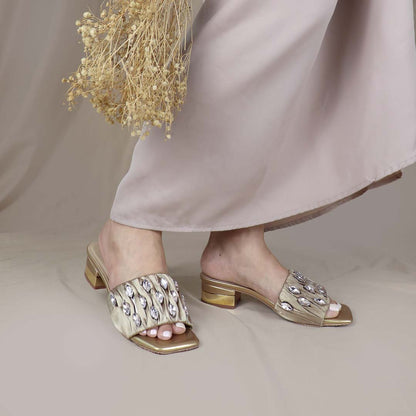 Model wearing Crystal Lux Satin Evening Heels in gold indoors, showcasing the luxe satin finish and statement crystal details — stylish yet comfortable heels for weddings, events, or formal dinners.