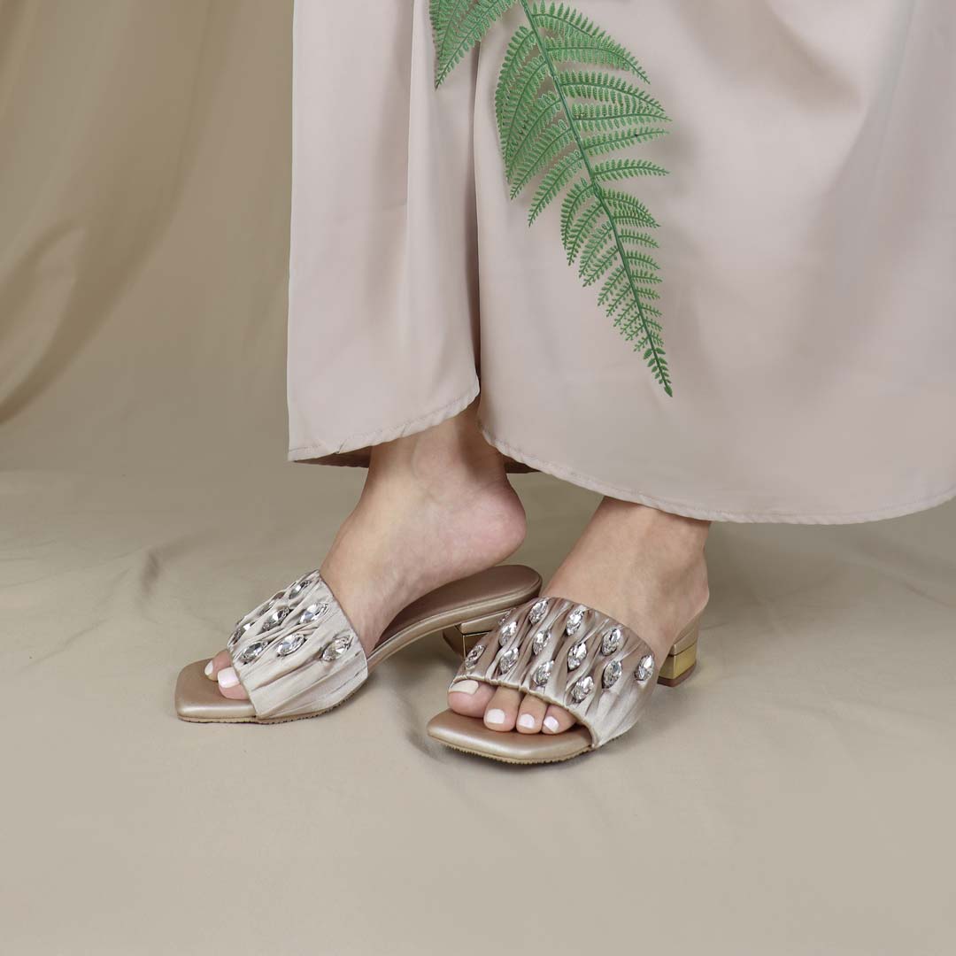 Model wearing Crystal Lux Satin Evening Heels in rose gold indoors, showcasing the luxe satin finish and statement crystal details — stylish yet comfortable heels for weddings, events, or formal dinners.