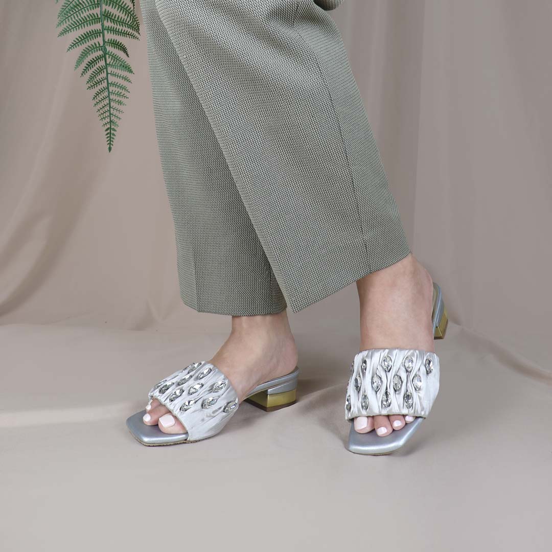 Model wearing Crystal Lux Satin Evening Heels in silver indoors, showcasing the luxe satin finish and statement crystal details — stylish yet comfortable heels for weddings, events, or formal dinners.