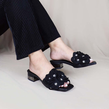 Model wearing Blooming Flower Evening Heels in a studio setting, showing the heels in use with sparkling floral accents adding charm to the outfit.