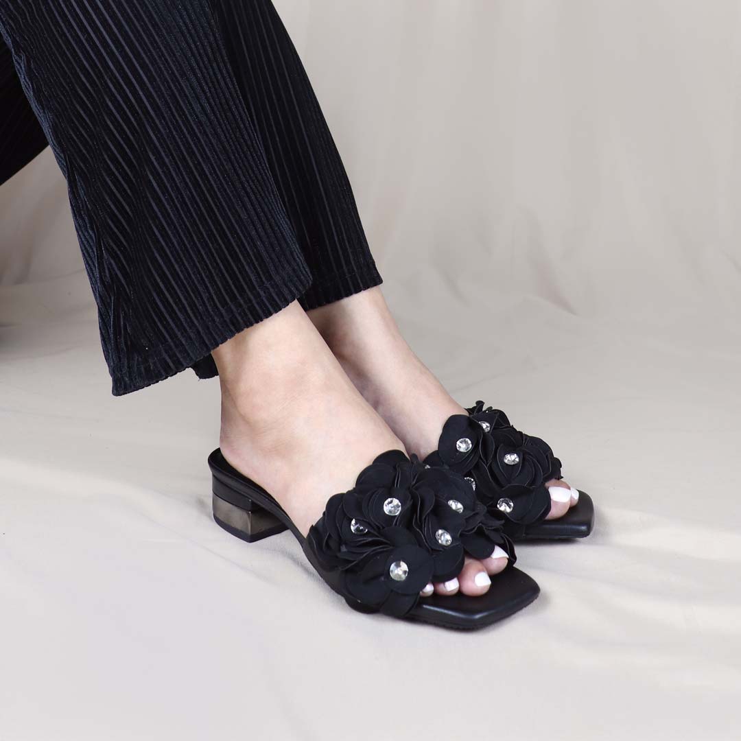 Model wearing Blooming Flower Evening Heels in a studio setting, in a diagonal view, showing the heels in use with sparkling floral accents adding charm to the outfit.