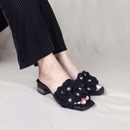 Model wearing Blooming Flower Evening Heels in a studio setting, in a diagonal view, showing the heels in use with sparkling floral accents adding charm to the outfit.