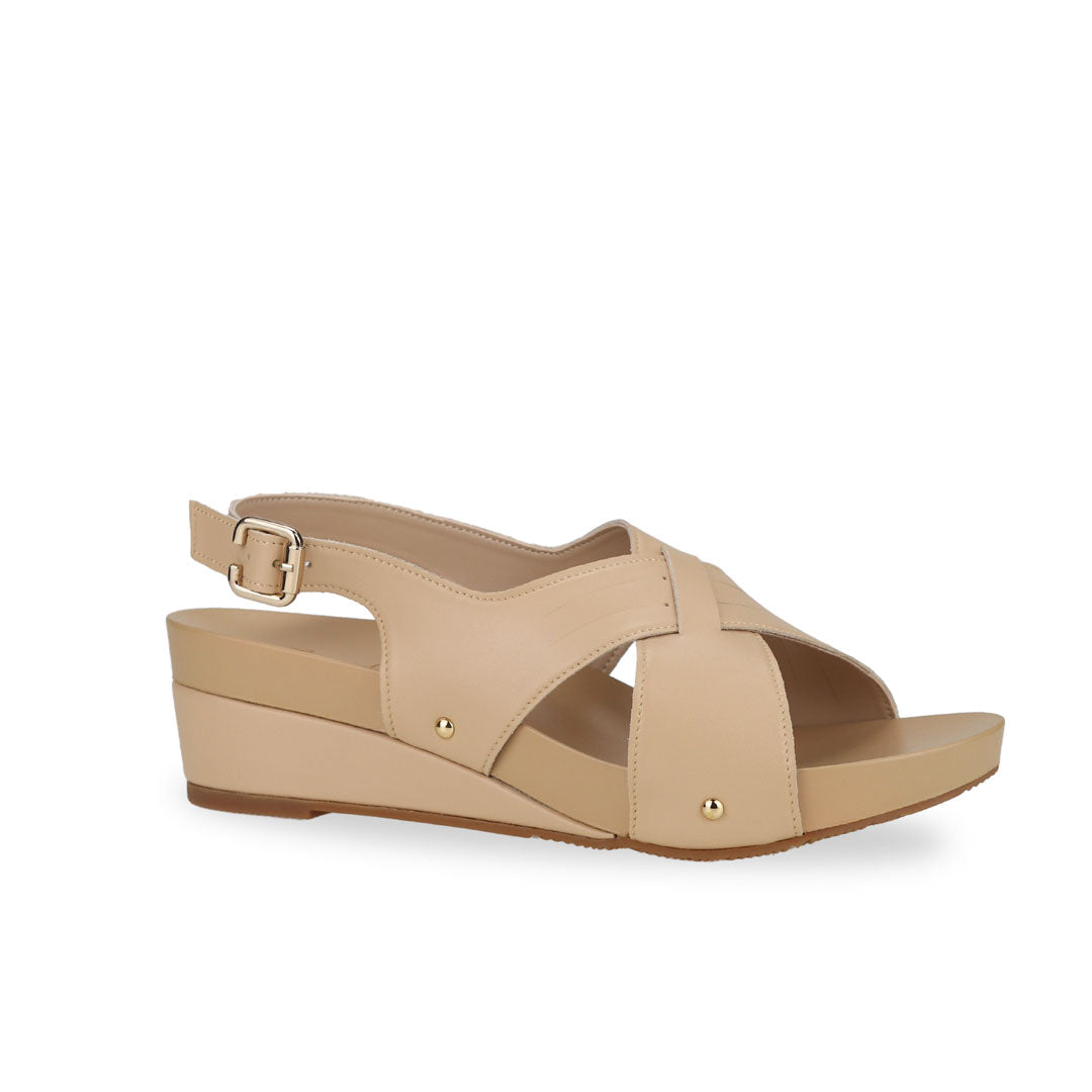 Diagonal view of Thomas Chan Cross Strap Slingback Low Wedge Sandals in cream, incorporating arch-support insoles for superior comfort and effortless walking experience.