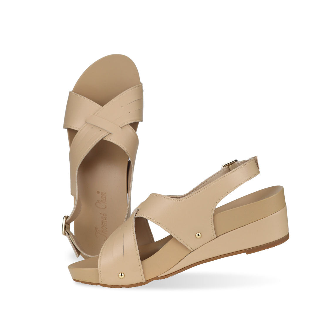 Full view of Thomas Chan Cross Strap Slingback Low Wedge Sandals in cream, incorporating arch-support insoles for superior comfort and effortless walking experience.