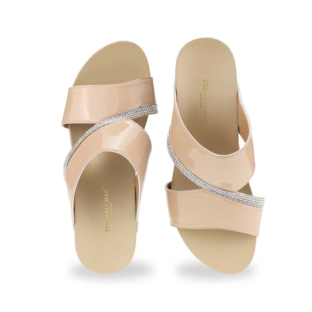 A close-up front angle showcasing the intricate diamond strap detailing that adds a refined touch to this dinner-ready wedge.