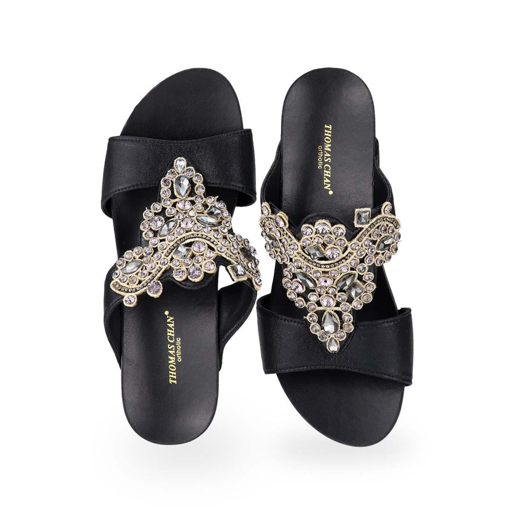 Front view of Thomas Chan's Vintage Rhinestone Low Wedge Sandals in black, adorned with vintage-inspired rhinestone detailing ,and an arch-support footbed.