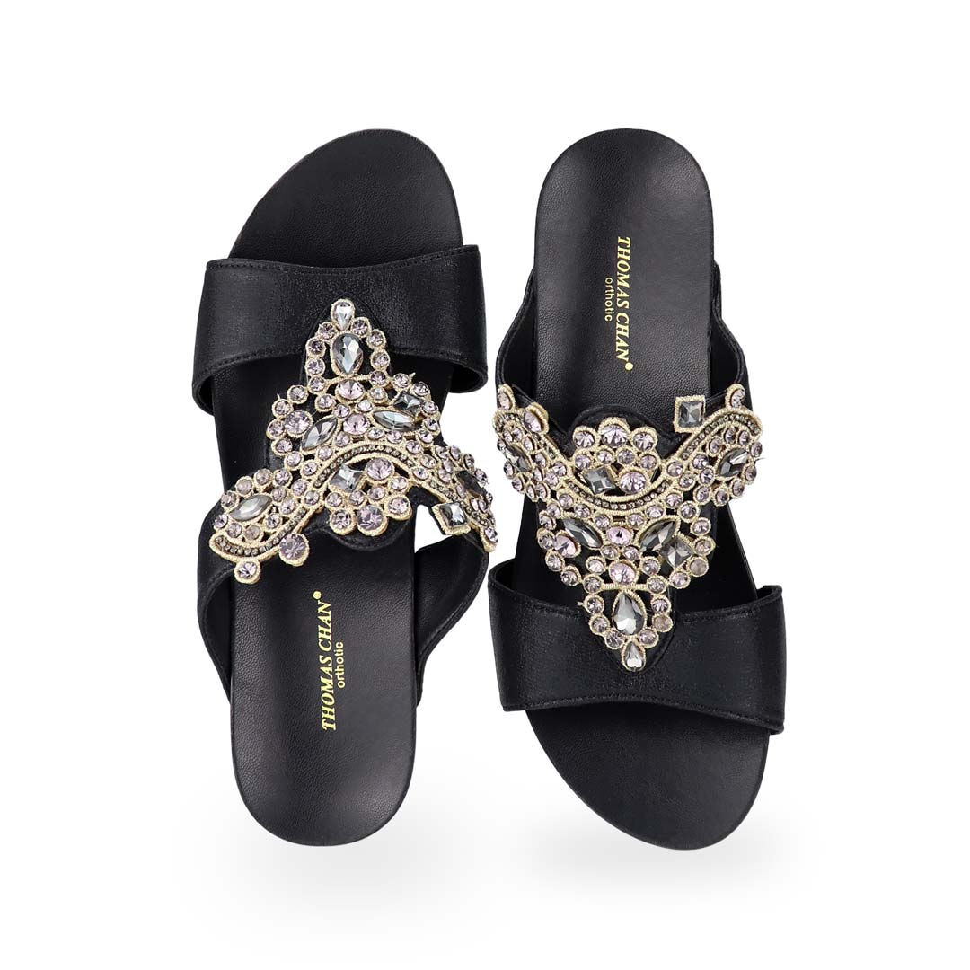 Front view of Thomas Chan's Vintage Rhinestone Low Wedge Sandals in black, adorned with vintage-inspired rhinestone detailing ,and an arch-support footbed.