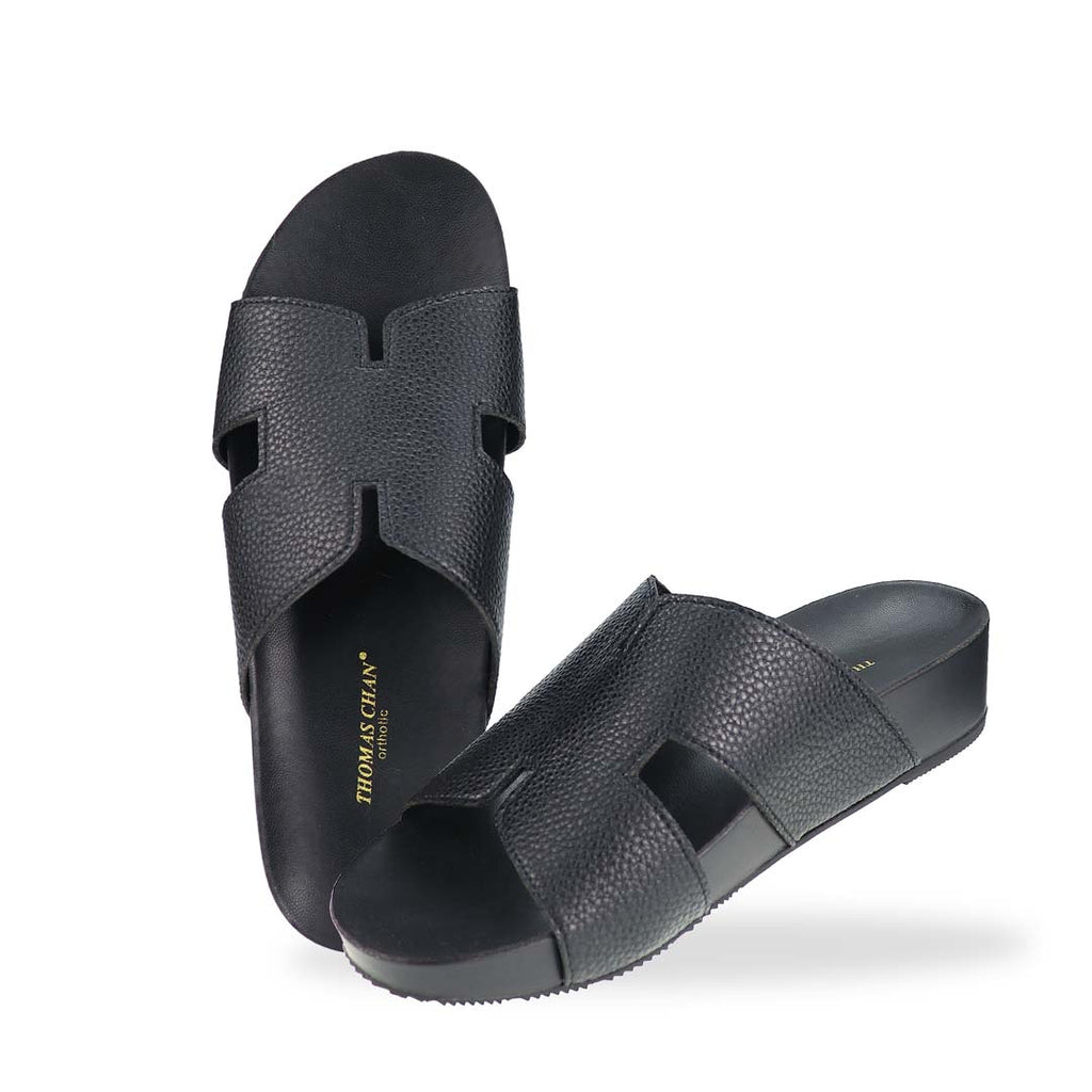 A complete top-down look at the H-Strap Pebble Lychee Flatform Sandals in black, emphasizing the minimalist design and wide-fit coverage