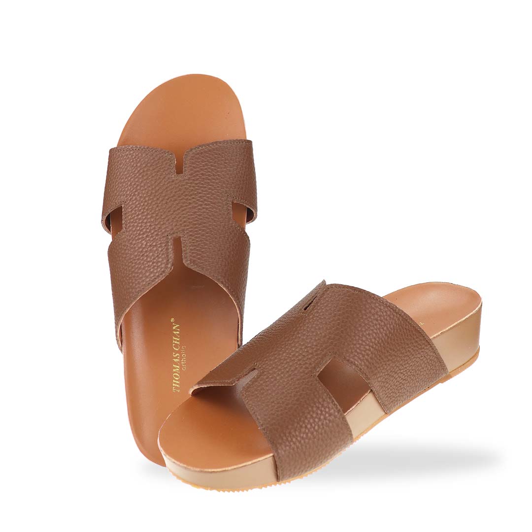 A complete top-down look at the H-Strap Pebble Lychee Flatform Sandals in brown, emphasizing the minimalist design and wide-fit coverage