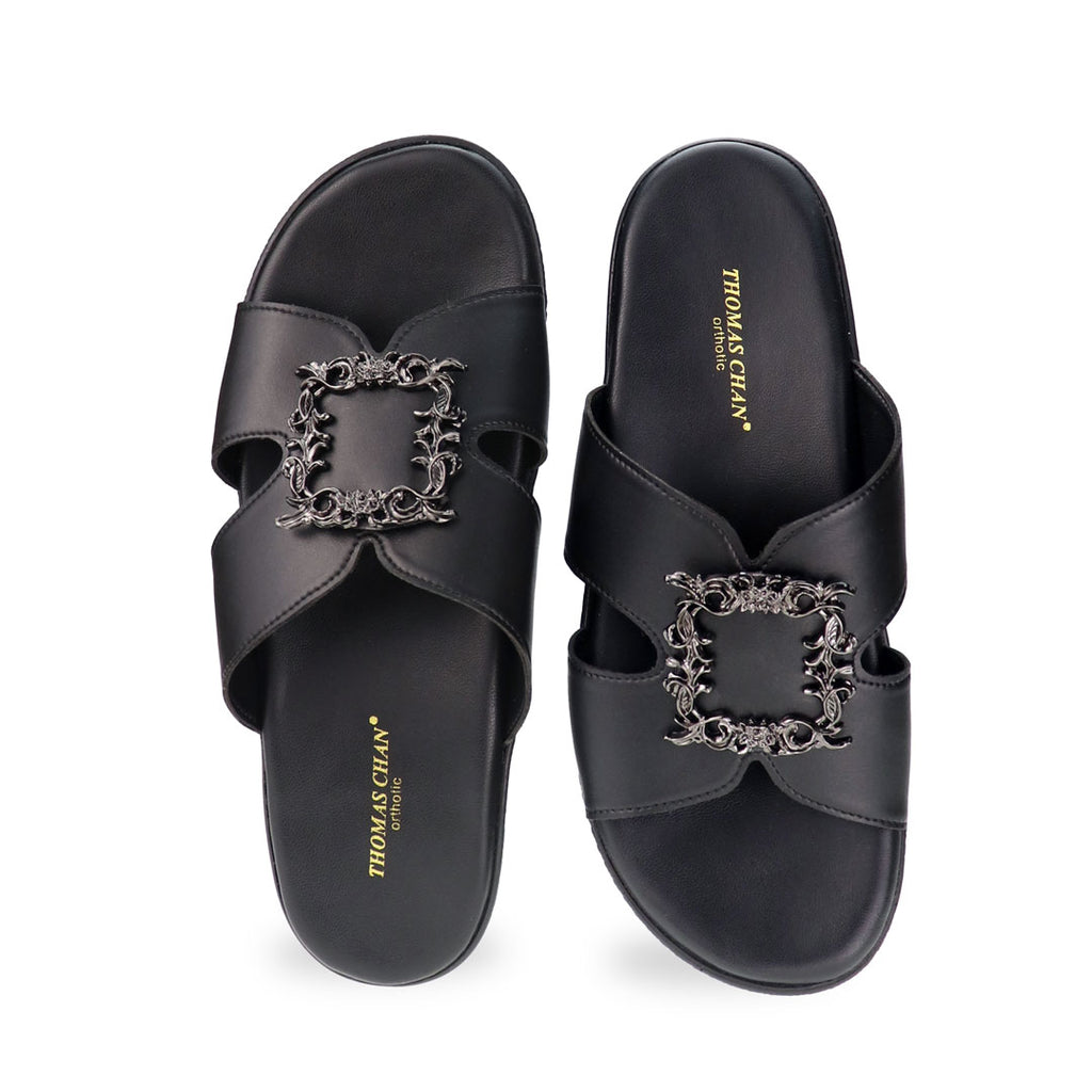 Front view of Thomas Chan Vintage Framed Flatform Sandals in black, featuring a wide, structured strap design and a centered black silver ornamental buckle.