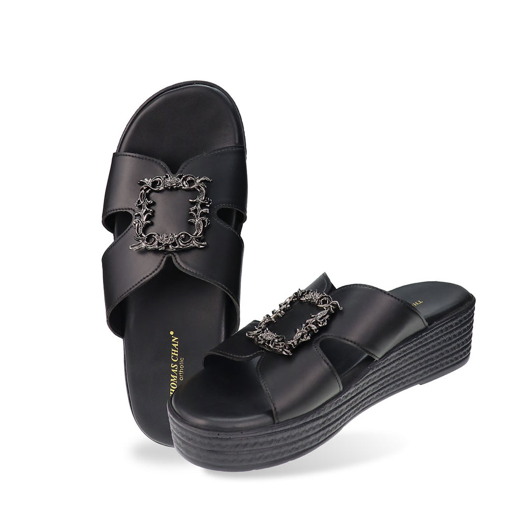 Full studio view of Thomas Chan Vintage Framed Flatform Sandals in black, showing both the cushioned footbed and side profile of the elegant sandal with a black silver vintage-style buckle.