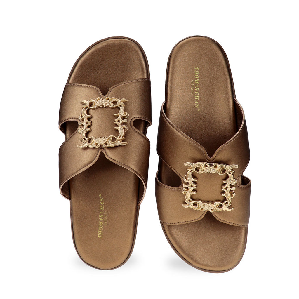 Front view of Thomas Chan Vintage Framed Flatform Sandals in bronze, featuring a wide, structured strap design and a centered gold ornamental buckle.