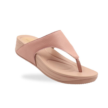 Thomas Chan’s pastel-tone pink flip-flop sandals shot at a diagonal angle in a studio setting, showcasing the pebbled lychee texture and contoured Bounce Care footbed.