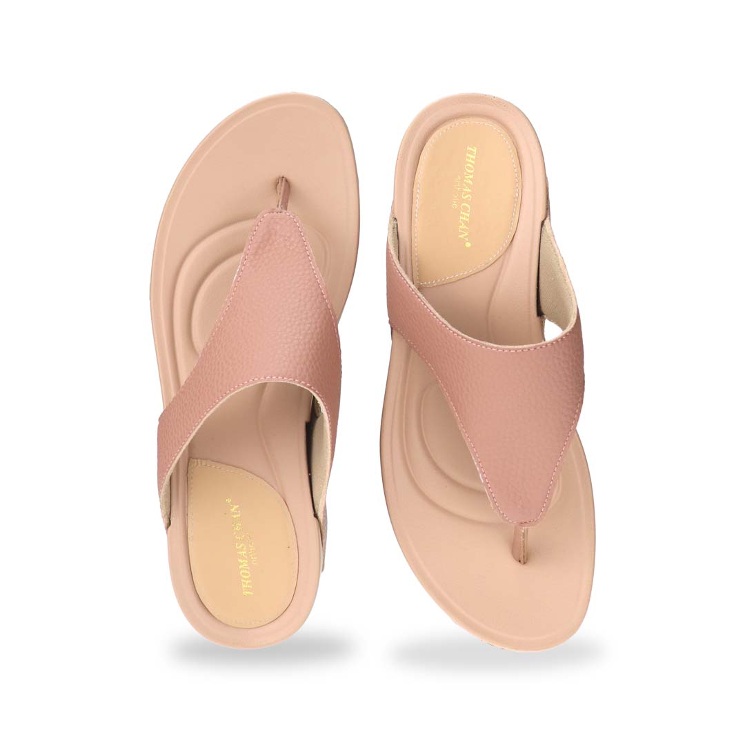 Frontal studio shot of the pink flip-flops, focusing on the toe post design and sleek, rounded front silhouette of the sandal.