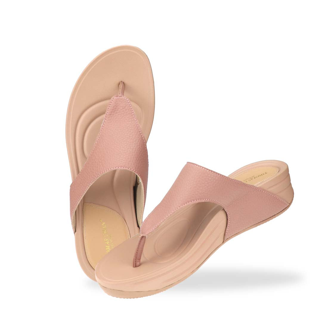 Top-down studio view of the pastel-tone pink sandals, displaying the full footbed structure, toe post, and wide strap with textured finish.