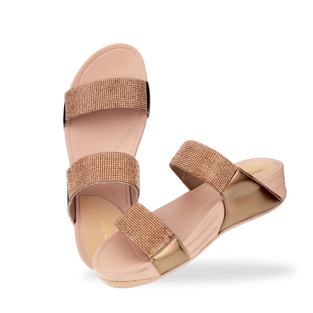 A full view of the Diamond Embellished Duo-Strap Bounce Care Sandals in Bronze, capturing its sleek design, soft rubber sole, and shimmering crystal accents. The elegant yet comfortable construction makes it a go-to footwear choice for effortless sophistication.