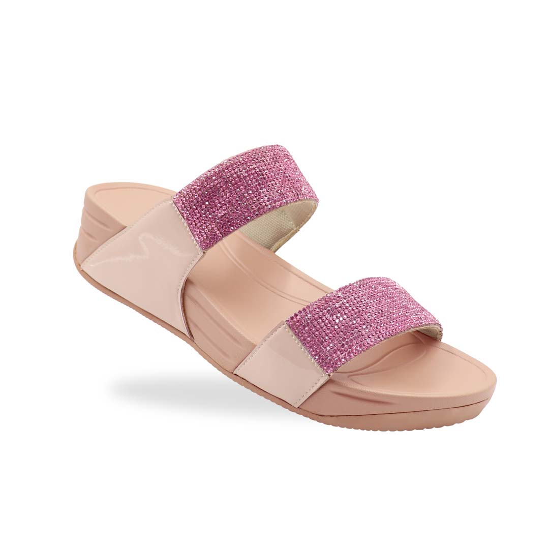 A diagonal view of the Diamond Embellished Duo-Strap Bounce Care Sandals in Nude Pink, highlighting the sparkling crystal-adorned straps and cushioned rubber sole. The slight elevation of the footbed is visible, offering both style and comfort against a neutral background.