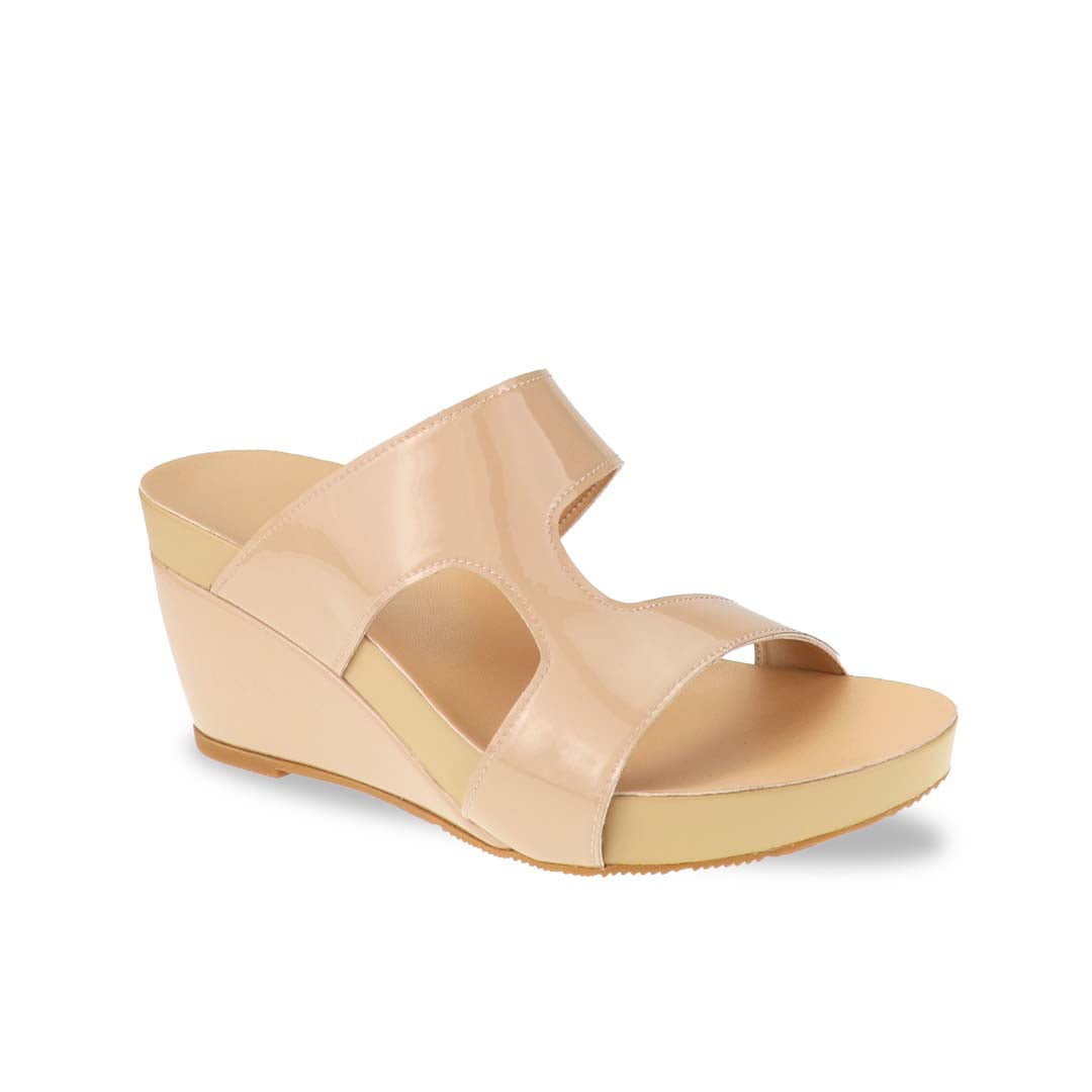 Thomas Chan Simplicité High Wedges photographed in studio at diagonal angle — nude beige minimalist sandals with clean curves and comfortable 3-inch wedge heel.