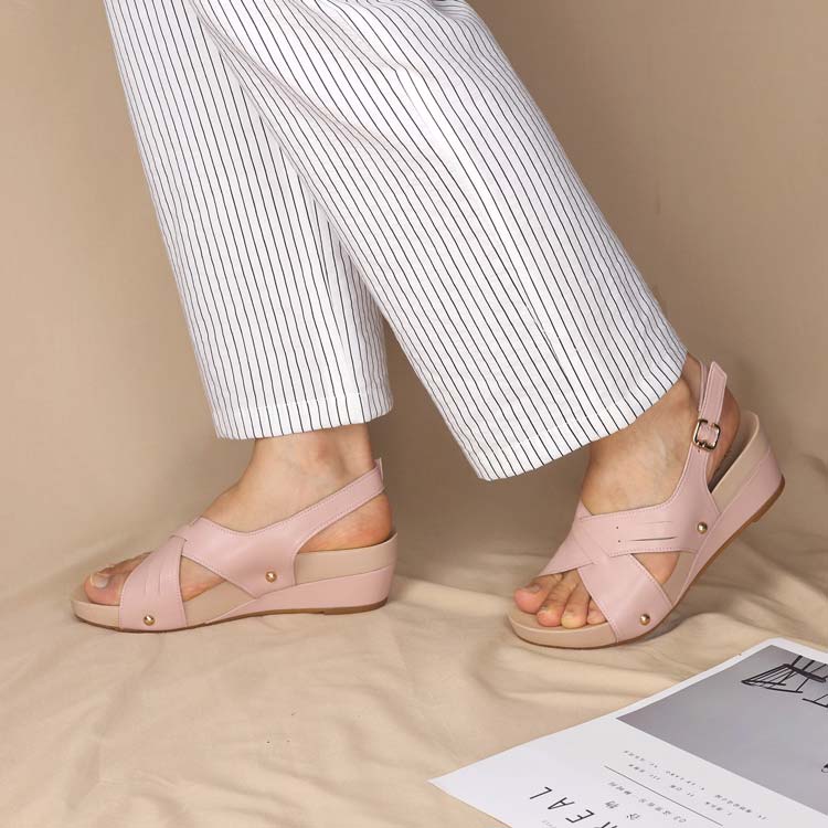 Model showcasing Thomas Chan Cross Strap Slingback Low Wedge Sandals in pink, featuring integrated arch-support insoles for optimal comfort and ease of walking