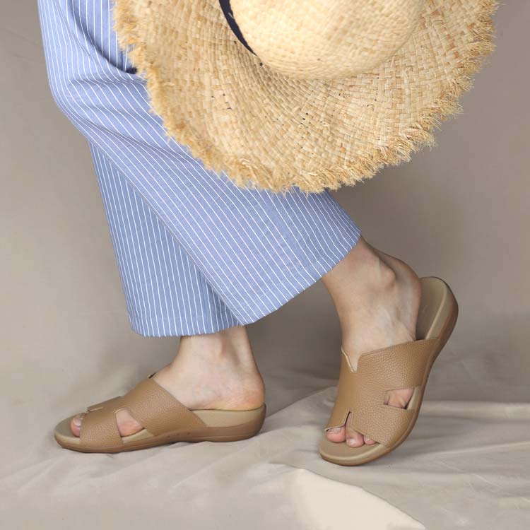 Outfit idea inspired by Morandi colors featuring light blue pants paired with light camel-colored Thomas Chan H-strap slip-on slide sandals for a stylish everyday look